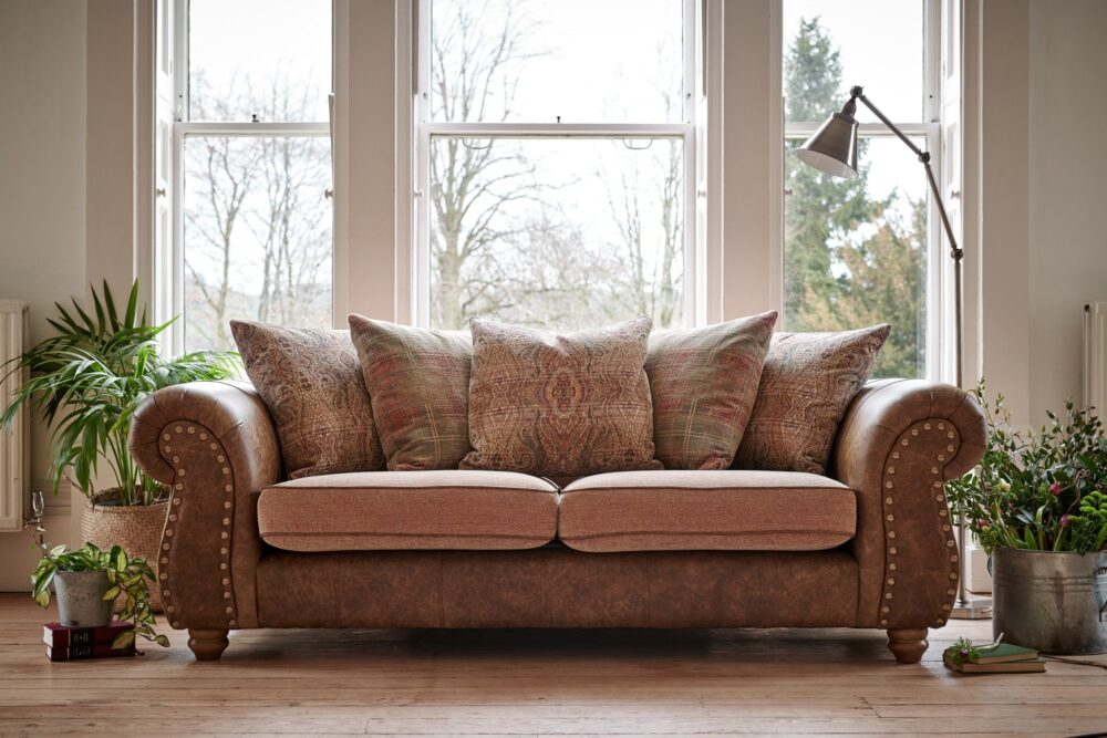 brown leather sofa and rugs