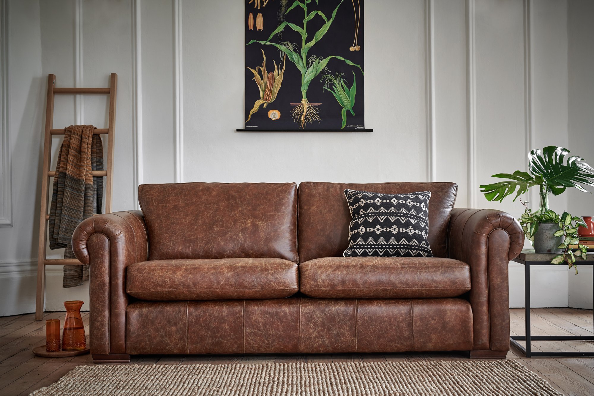 brown leather sofa with material cushions