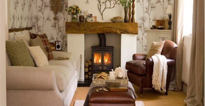 Traditional leather sofa and foot stool, wood fire and fireplace