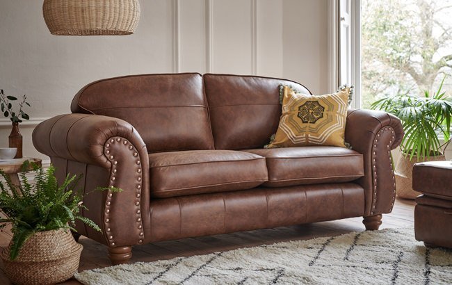 brown leather sofa with grey carpet